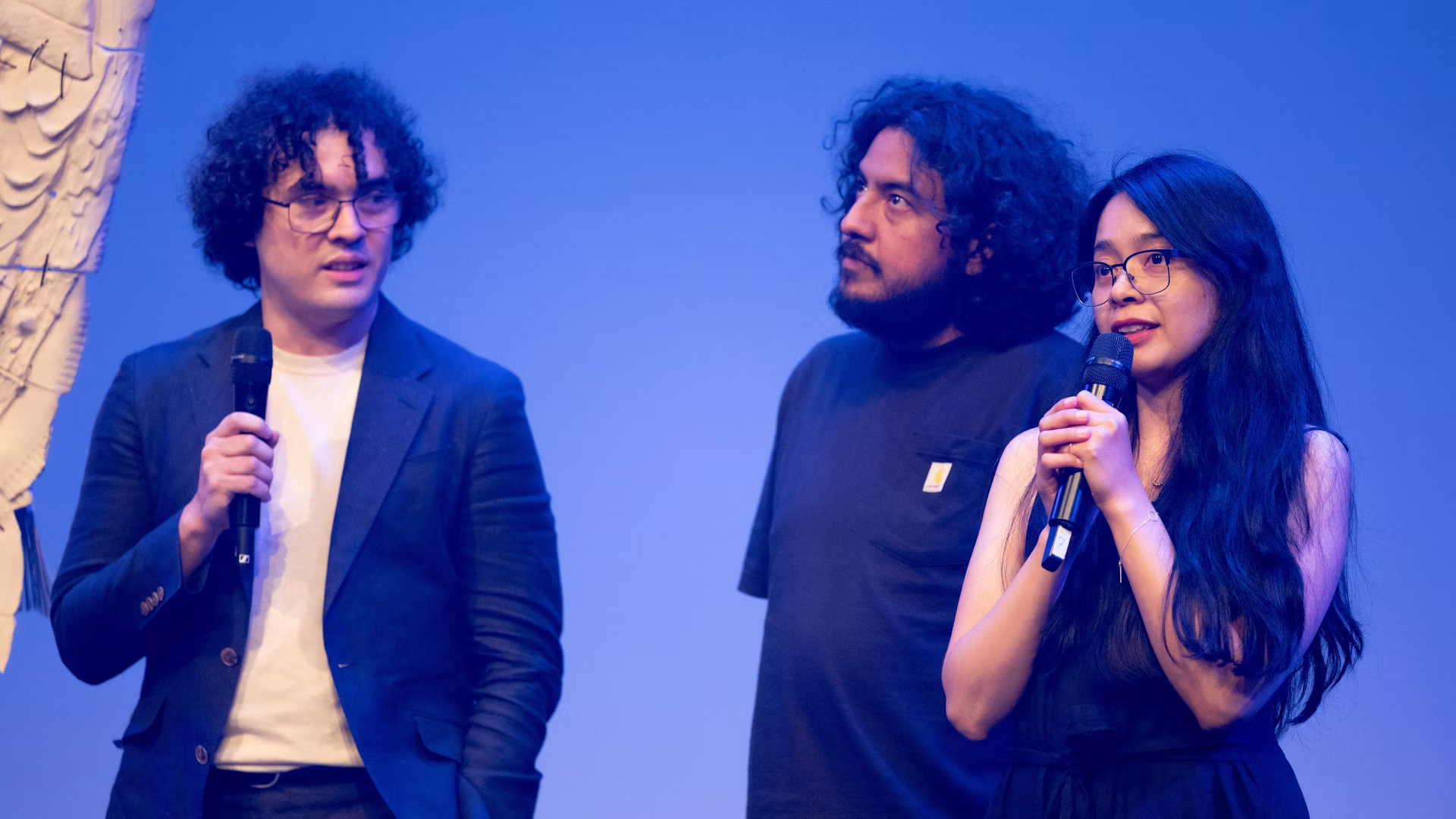 Members of the artistic team speak with microphones after the Graz presentation.